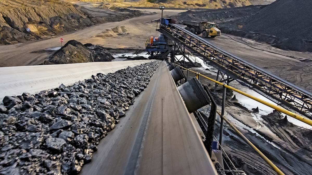 A conveyor belt moving coal from a mine in the mountains